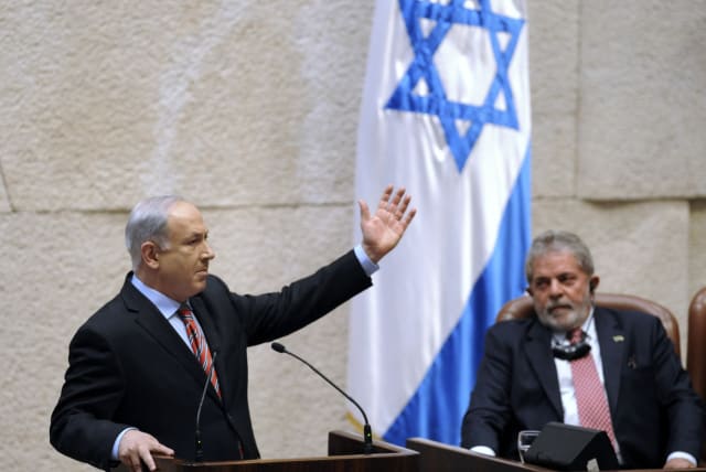  Brazil's Luiz Inacio Lula da Silva listens as Prime Minister Benjamin Netanyahu addresses the Knesset in Jerusalem, March 15, 2010 (photo credit: REUTERS/YIN BOGU/POOL)