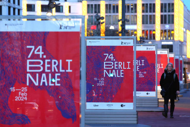  A pedestrian walks past advertising billboards for the upcoming 74th Berlinale International Film Festival in Berlin, Germany, February 13, 2024.  (photo credit: Fabrizio Bensch/Reuters)