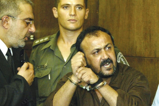  MARWAN BARGHOUTI addresses the media in the Tel Aviv District Court, in 2002, shouting in Hebrew: ‘The Intifada will win.’ A convicted mass murderer, Barghouti has been jailed since 2002, the writer notes. (photo credit: REUTERS)