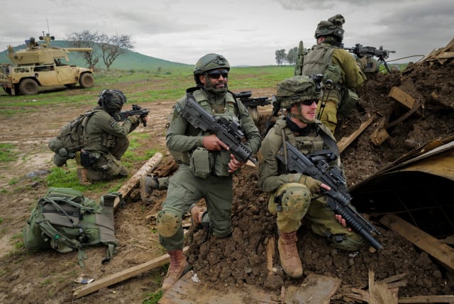  Israeli reserve soldiers from the Nachal brigade take part in a military drill in the Golan Heights, northern Israel, February 13, 2024.  (photo credit: MICHAEL GILADI/FLASH90)