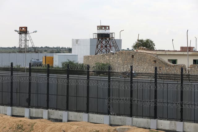  A BORDER FENCE separates the Gaza Strip and Egypt, at Rafah. From the Egyptian perspective, Israel taking control of the Philadelphi Corridor while ‘encouraging the migration of Gazans to Egypt,’ as several Israeli politicians have stated, constitutes a red line, says the writer. (photo credit: IBRAHEEM ABU MUSTAFA/REUTERS)