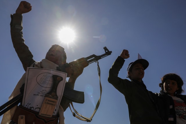  A boy holds a rifle as he takes part in a pro-Palestinian protest by Houthi supporters in Sanaa, Yemen February 18, 2024. (photo credit: REUTERS/KHALED ABDULLAH)