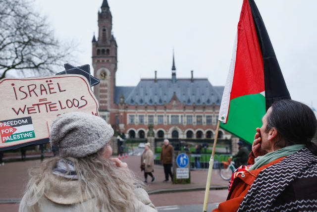 People protest on the day of a public hearing held by The International Court of Justice (ICJ) in The Hague, Netherlands, February 21, 2024 (photo credit: PIROSCHKA VAN DE WOUW/REUTERS)
