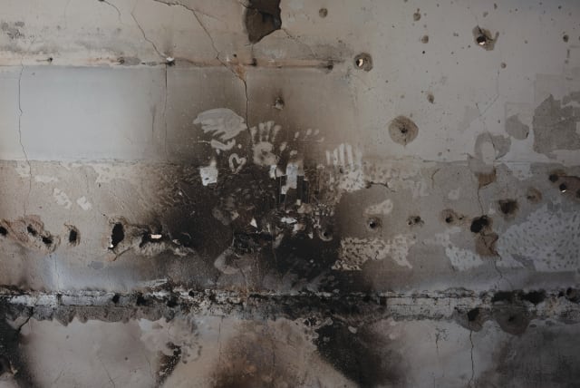  ‘BEARING WITNESS,’ 2023. The scorched wall, pockmarked with bullet holes, bears witness to the harrowing struggle for survival endured by the 17 people trapped within its confines.   (photo credit: CHEN SCHIMMEL)