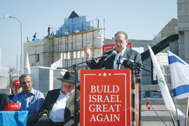  FORMER ARKANSAS governor and past US Republican presidential nomination candidate Mike Huckabee helps inaugurate a program to build more in Efrat, Gush Etzion, in 2018. Settler leaders tend to think the worst of the US and its presidents, argues the writer. (photo credit: GERSHON ELINSON/FLASH90)