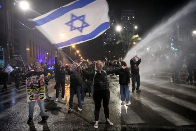  Police use a water cannon to disperse protesters during a protest against Israeli Prime Minister Benjamin Netanyahu and the current Israeli government, in Tel Aviv, on February 24, 2024. (photo credit: MIRIAM ALSTER/FLASH90)