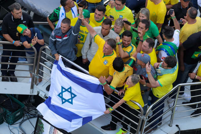  Brazil's former president Jair Bolsonaro reacts next to an Israeli flag during a protest where he called his supporters to gather in Paulista Avenue, as police investigate him and his cabinet for allegedly plotting a coup after the 2022 election, in Sao Paulo, Brazil, February 25, 2024. (photo credit: REUTERS/Carla Carniel)