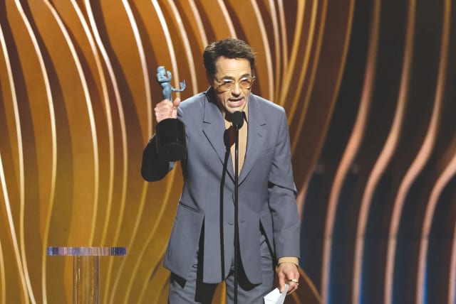  ROBERT DOWNEY, JR. receives the Outstanding Performance by a Male Actor in a Supporting Role award for ‘Oppenheimer’ at the 30th Screen Actors Guild Awards, in Los Angeles, last month. (photo credit: MARIO ANZUONI/REUTERS)