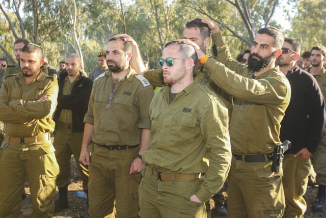  IDF SOLDIERS visit the site of the Supernova music festival massacre in Re’im, near the Israel-Gaza border. While the Israeli people are still at war, it is too early to fully understand the effects of the Hamas attacks on the country and the people, says the writer.  (photo credit: EDI ISRAEL/FLASH90)