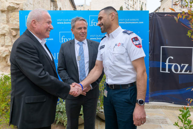  SHIN BET Director Avi Dichter (L) greets Anir Abu Dabes, a Bedouin MDA medic from Rahat, who was among the first responders to arrive in Ofakim, saving lives while under fire, as Avi Benlolo, CEO of The Abraham Global Peace Initiative, who spearheaded the tribute, looks on. (photo credit: Shmulik Cohen)