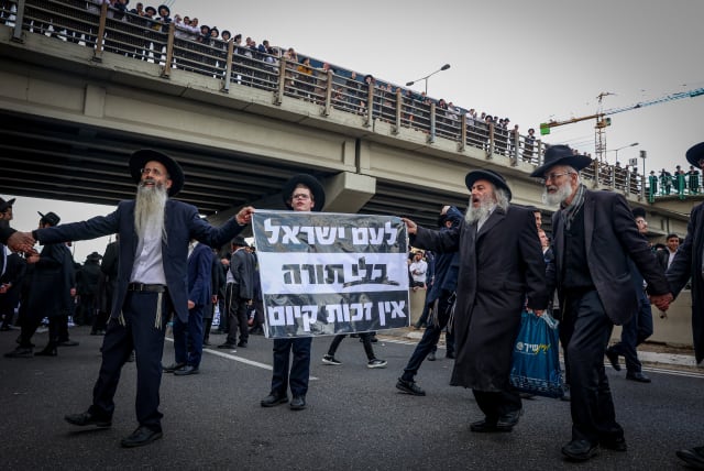  Ultra-Orthodox Jews block a road during a protest outside the city of Bnei Brak, March 3, 2024 (photo credit: ITAI RON/FLASH90)