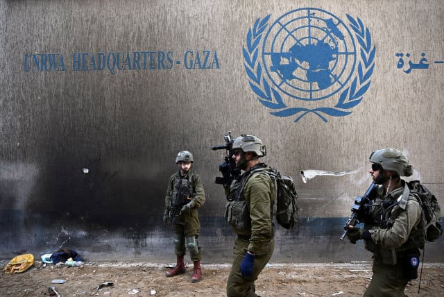  Israeli soldiers operate next to the UNRWA headquarters, amid the ongoing conflict between Israel and the Palestinian Islamist group Hamas, in the Gaza Strip, February 8, 2024.  (photo credit: DYLAN MARTINEZ/REUTERS)