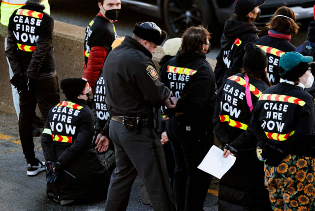  Protesters from the national group Jewish Voice for Peace are arrested for blocking traffic on I-76 during a call for a ceasefire in the Israel-Hamas war during rallies across the U.S. marking the 8th night of Hanukkah, in Philadelphia, Pennsylvania, U.S., December 14, 2023. (photo credit: Hannah Beier/Reuters)