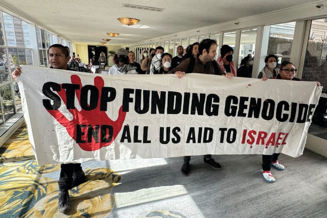  PROTESTERS ACCUSE the US of funding genocide in Gaza, as they descend on a hotel where US President Joe Biden was staying in San Francisco last month.  (photo credit: KEVIN LAMARQUE/REUTERS)