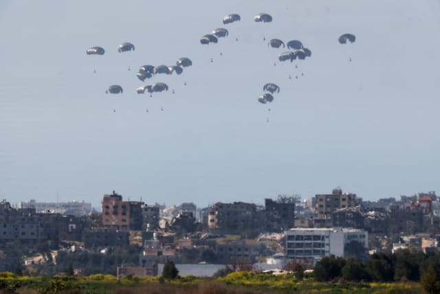  Packages fall towards Gaza, after being dropped from a military aircraft, amid the ongoing conflict between Israel and the Palestinian group Hamas, as seen from Israel's border with Gaza in southern Israel March 5, 2024.  (photo credit: AMIR COHEN/REUTERS)