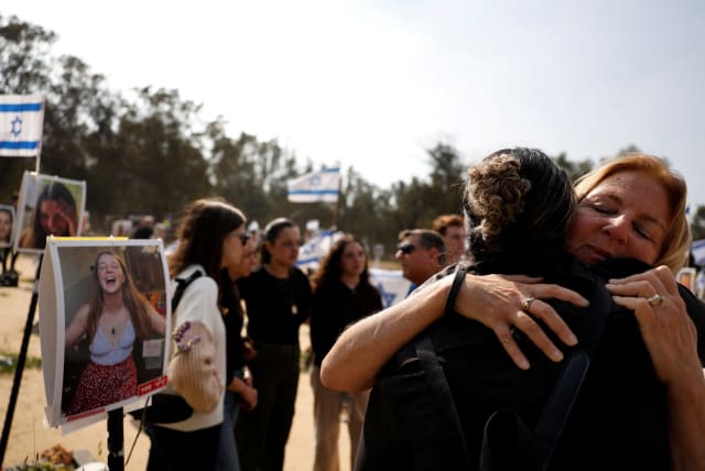  Orna Adar, mother of Gili Adar, who was killed during the October 7 attack by Hamas gunmen from Gaza, gets hugged next to her memorial, amid the ongoing conflict between Israel and the Palestinian Islamist group Hamas, in Reim, southern Israel, February 25, 2024. (photo credit: SUSANA VERA/REUTERS)