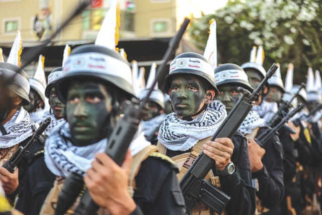  PALESTINIAN ISLAMIC Jihad supporters participate in an anti-Israel rally marking the 36th anniversary of the movement’s foundation, in Gaza City on the day before the October 7 attack on Israel.  (photo credit: ATIA MOHAMMED/FLASH90)
