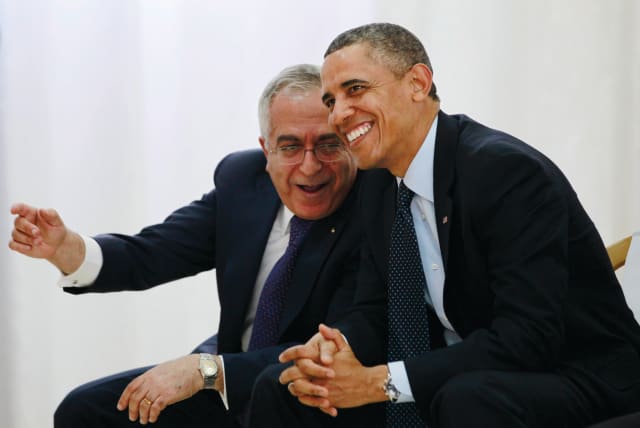  THEN-US president Barack Obama watches a cultural event alongside then-Palestinian prime minister Salam Fayyad in Ramallah, in 2013.  (photo credit: JASON REED/REUTERS)