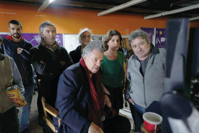  A BEHIND-THE-SCENES photo of ‘Shikun’ with Amos Gitai (center) and Irene Jacob (second from right).  (photo credit: Ziv Koren/United King Films)