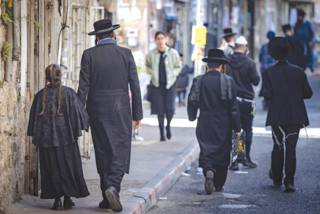  HAREDI JEWS walk in the streets of the ultra-Orthodox neighborhood of Mea Shearim, in Jerusalem, earlier this month. (photo credit: Chaim Goldberg/Flash90)