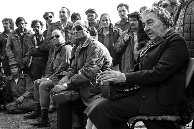  THEN-PRIME MINISTER Golda Meir is accompanied by defense minister Moshe Dayan, as they meet with IDF soldiers on the Golan Heights during the 1973 Yom Kippur War. Egypt and Syria launched an attack against Israel on Yom Kippur – during the month of Ramadan.  (photo credit: REUTERS)