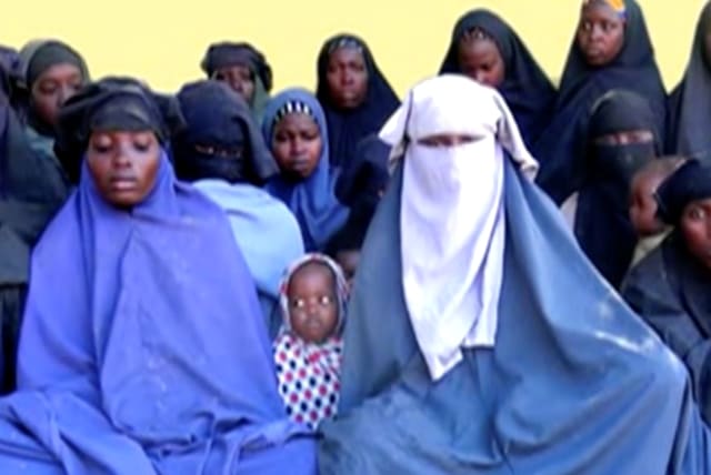  Remaining girls who were kidnapped from the northeast Nigerian town of Chibok are seen in an unknown location in Nigeria in this still image taken from an undated video obtained on January 15, 2018.  (photo credit: BOKO HARAM HANDOUT/SAHARA REPORTERS VIA REUTERS)