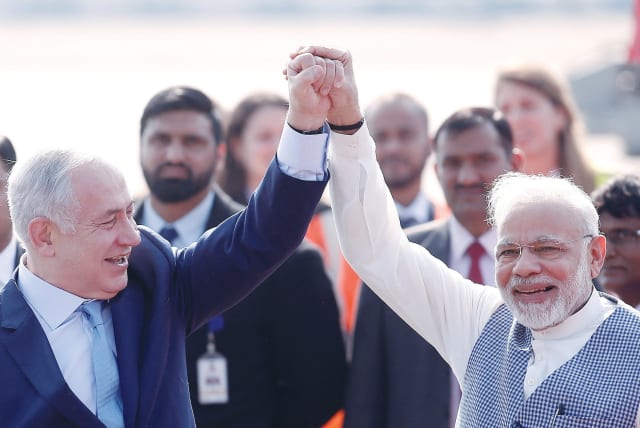  PRIME MINISTER Benjamin Netanyahu and his Indian counterpart, Narendra Modi, raise their arms upon Netanyahu’s arrival at Air Force Station Palam in New Delhi, in 2018.  (photo credit: Adnan Abidi/Reuters)