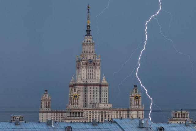  A bolt strikes near Moscow State University building during a thunderstorm in Moscow, Russia July 5, 2022. (photo credit: MAXIM SHEMETOV/REUTERS)