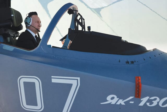  RUSSIAN PRESIDENT Vladimir Putin sits in a cockpit of a flight simulator at the Higher Military Aviation School of Pilots in Krasnodar, Russia, last week. When Putin invaded Ukraine two years ago, he envisioned a swift blitz on the Ukrainian capital, severing its government in a matter of days, say (photo credit: SPUTNIK/REUTERS)
