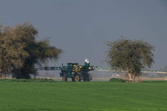  A farming vehicle with an Israeli flag works on a field near the border with southern Gaza, amid the ongoing conflict between Israel and the Palestinian Islamist group Hamas, Israel, February 12, 2024. (photo credit: AMIR COHEN/REUTERS)