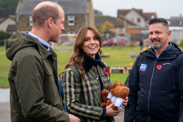 Britain's Prince William, and Kate, the Princess of Wales also known as the Duke and Duchess of Rothesay when in Scotland, are presented with 3 teddy bears for their children during their visit to Outfit Moray, in Moray, Scotland, Britain November 2, 2023. (photo credit: JANE BARLOW/POOL/REUTERS)