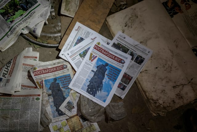  Propaganda newspapers are seen inside a school building that was used by occupying Russian troops as a base in the settlement of Bilozerka, amid Russia's attack on Ukraine, in Kherson region, Ukraine, December 2, 2022. (photo credit: REUTERS/ANNA VOITENKO)