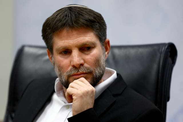   Israeli Finance Minister Bezalel Smotrich attends a news conference after announcing that he will sign an order to seize Palestinian Authority funds and transfer them to the families of victims of Palestinian attacks, at Israel's Finance Ministry in Jerusalem, January 8, 2023.  (photo credit: RONEN ZVULUN/REUTERS)