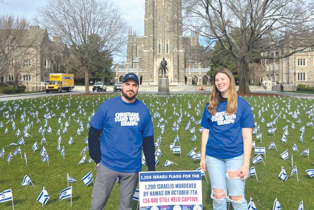  THE WRITER (left) stands at a flag-planting demonstration in which 1,200 Israeli flags were installed on a lawn at Duke University, each flag representing an Israeli murdered on October 7. (photo credit: PASSAGES)