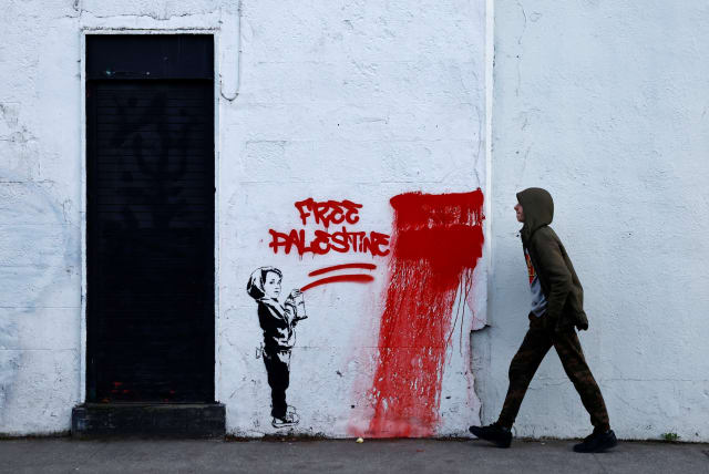  A man walks past graffiti reading 'Free Palestine', amid the ongoing conflict between Israel and the Palestinian Islamist group Hamas, in Dublin, Ireland, November 15, 2023. (photo credit: REUTERS/CLODAGH KILCOYNE)