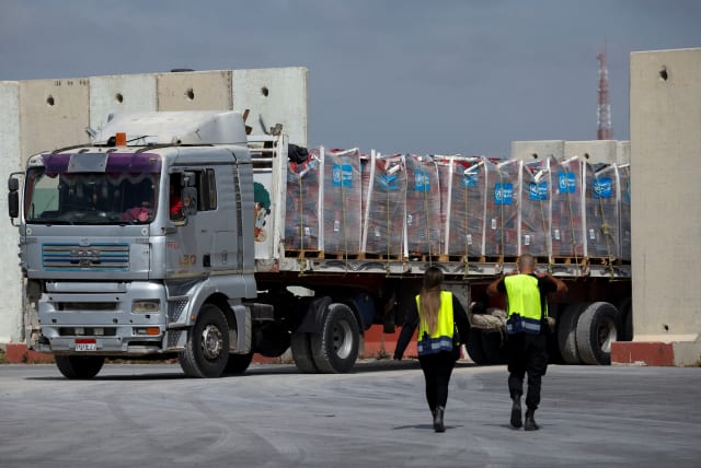  A truck carrying humanitarian aid bound for the Gaza Strip drives at the inspection area at the Kerem Shalom crossing, amid the ongoing conflict between Israel and the Palestinian Islamist group Hamas, in southern Israel, March 14, 2024.  (photo credit: REUTERS/Carlos Garcia Rawlins TPX IMAGES OF THE DAY)