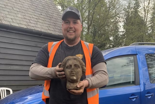 Greg Crawley and the ancient Roman statue he unearthed. (photo credit: Burghley House)
