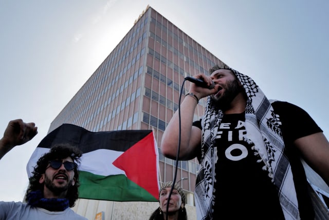  A person uses a microphone during a protest near the perimeter of the 96th Academy Awards, amid the ongoing conflict between Israel and the Palestinian Islamist group Hamas, in Los Angeles, California, U.S., March 10, 2024.  (photo credit: REUTERS/CARLIN STIEHL)