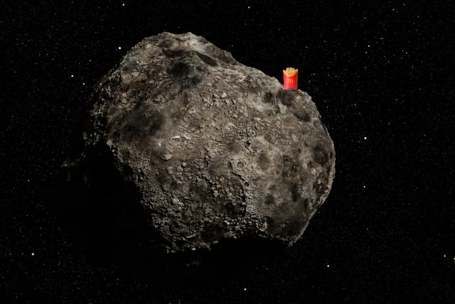  An illustrative image of McDonald's French fries atop an asteroid in space. (photo credit: dottedhippo/Getty Images, Africa images via Canva)