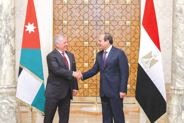  EGYPT’S PRESIDENT Abdel Fattah al-Sisi shakes hands with Jordan’s King Abdullah during a summit in Cairo, in December. Egypt and Jordan have declared that the displacement of Palestinians is a red line for maintaining relations with Israel, the writer notes.  (photo credit: THE EGYPTIAN PRESIDENCY/REUTERS)