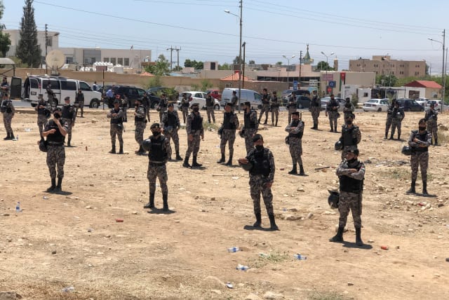  Security forces are seen during a protest to express solidarity with the Palestinian people, in Karameh, Jordan valley, Jordan May 15, 2021. (photo credit: JEHAD SHELBAK/REUTERS)