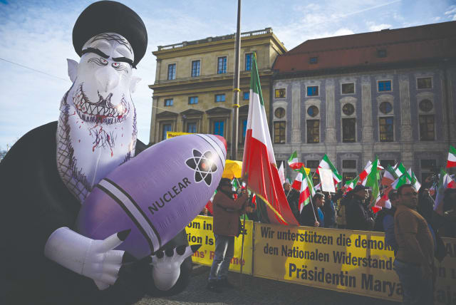  PROTESTING THE Iranian regime with flags and a huge inflated figure representing Supreme Leader Ali Khamenei holding a nuclear bomb, near the Munich Security Conference venue, Feb. 16. (photo credit: Tobias Schwarz/AFP via Getty Images)