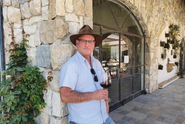  WINEMAKER SAM SOROKA outside Psagot Winery with his ever-present hat, a much-valued purchase from Argentina; and in the vineyard predictably with his dog. He is a great animal lover. (photo credit: Sam Soroka)