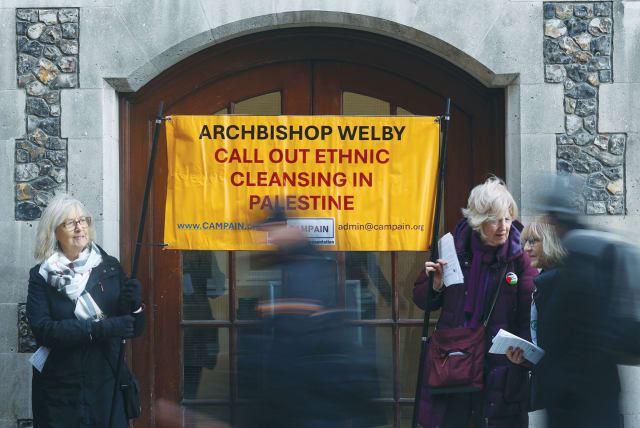  PROTESTERS HOLD a banner outside the opening session of the Church of England General Synod, in London, last month. (photo credit: TOBY MELVILLE/REUTERS)