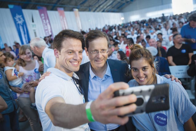  PRESIDENT ISAAC Herzog, then the new chairman of the Jewish Agency, attends a 2018 event welcoming new immigrants from France. The question remains valid, says the writer, should Jews in the Diaspora stay or leave?  (photo credit: MIRIAM ALSTER/FLASH90)