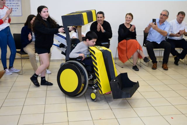  A child with his wheelchair dressed as a bulldozer. (photo credit: Courtesy)