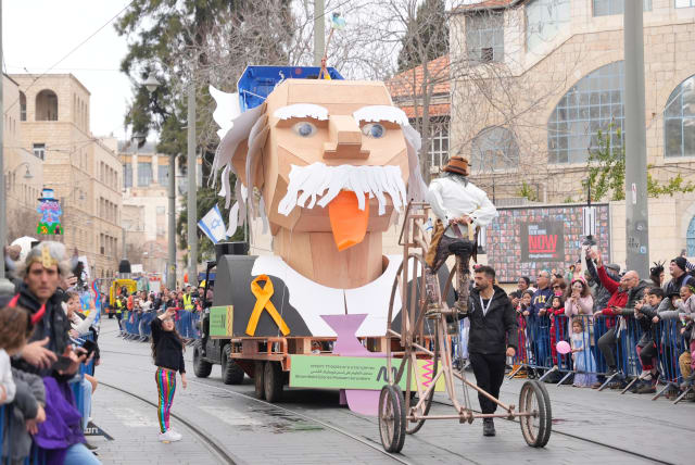 A float of Einstein at the Purim parade in Jerusalem, with a yellow ribbon for the hostages on the front of it. March 25, 2023 (photo credit: JERUSALEM MUNICIPALITY)