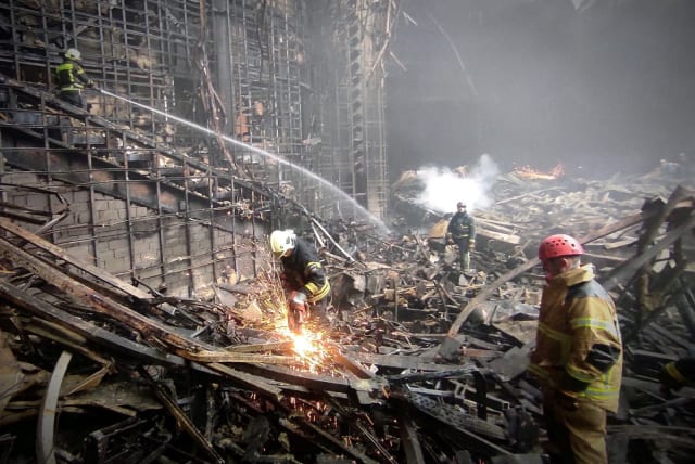   Members of the Russian Emergencies Ministry carry out search and rescue operations at the Crocus City Hall concert venue after a shooting attack and fire, outside Moscow, Russia, in this picture obtained March 24, 2024.  (photo credit: PICTURE OBTAINED BY REUTERS/File Photo)