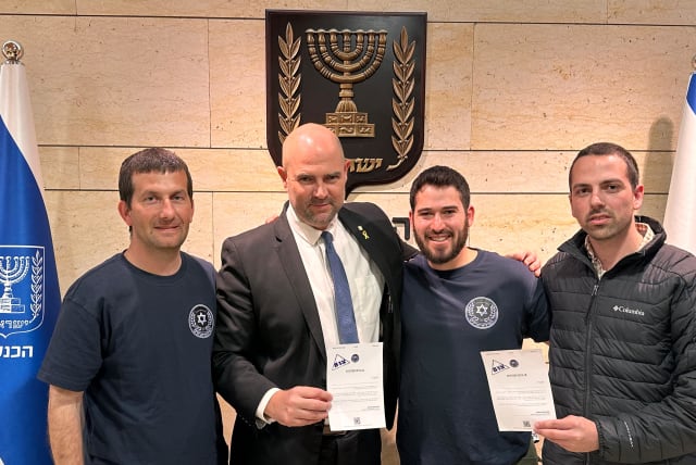  Speaker of the Knesset Amir Ohana holds up his "Tzav 8 for Unity" letter with IDF reservists, March 27, 2024. (photo credit: Via Maariv)