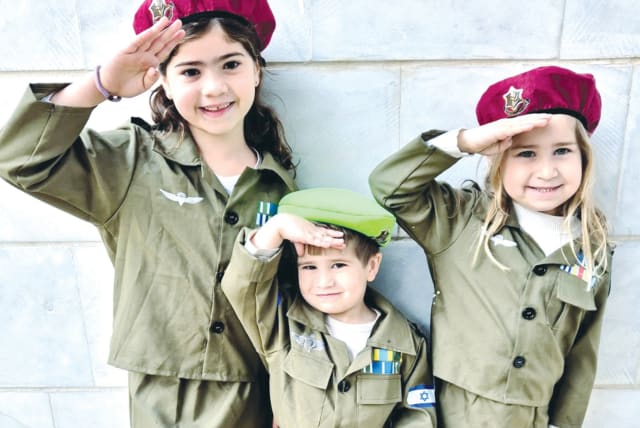  Children celebrate Purim, dressed in soldier costumes. (photo credit: RENA MEDNICK)